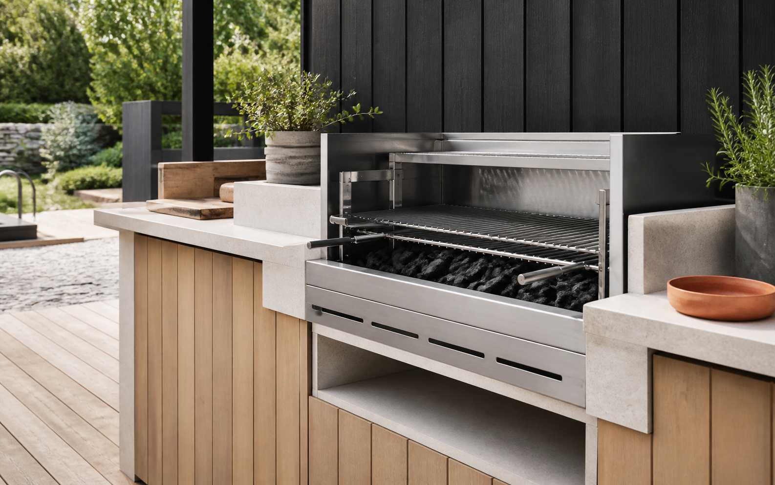 Built-in stainless steel charcoal grill in outdoor kitchen